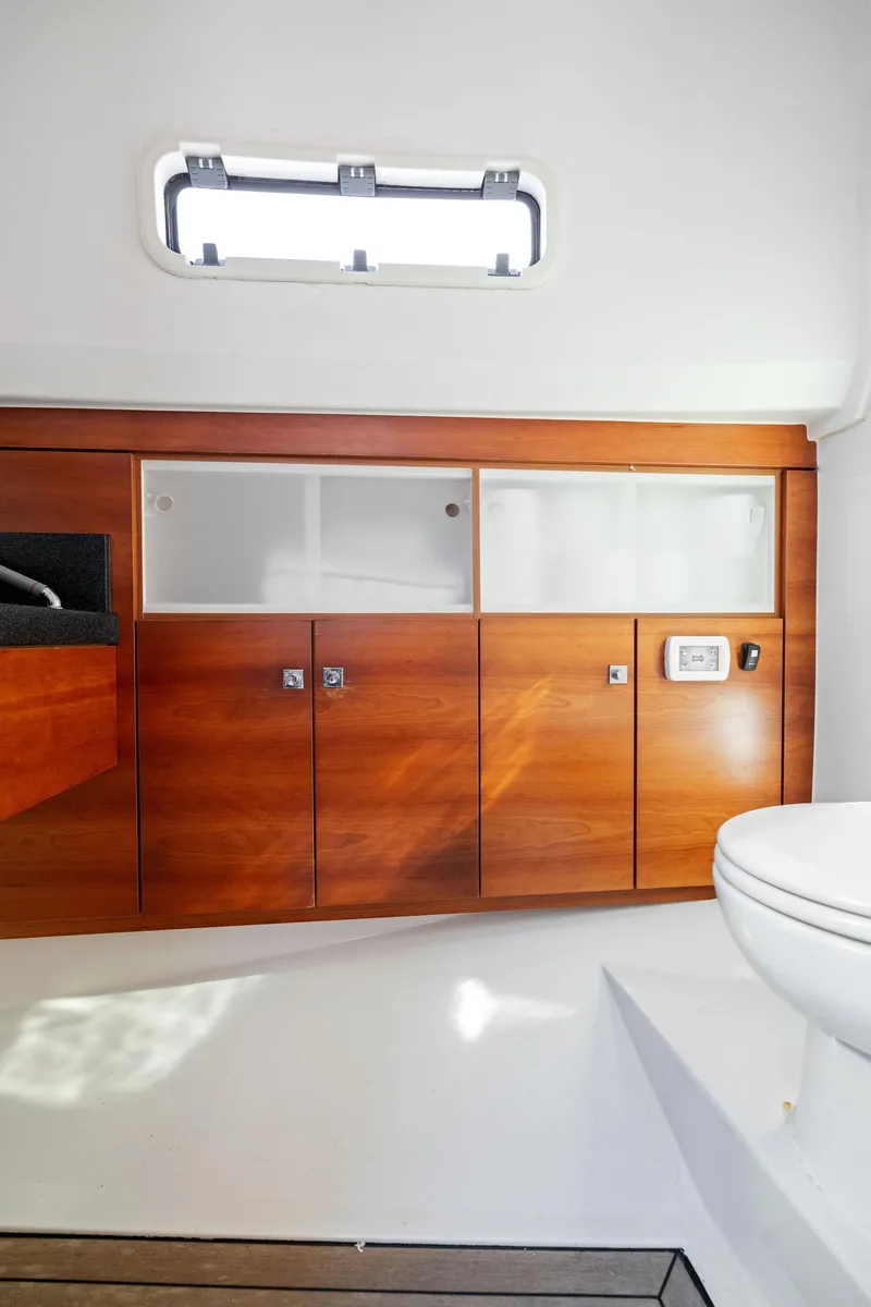 Slide: The Image of Interior of 2011 Fjord 40 Open yacht, featuring sleek wooden cabinetry and modern design. - 46