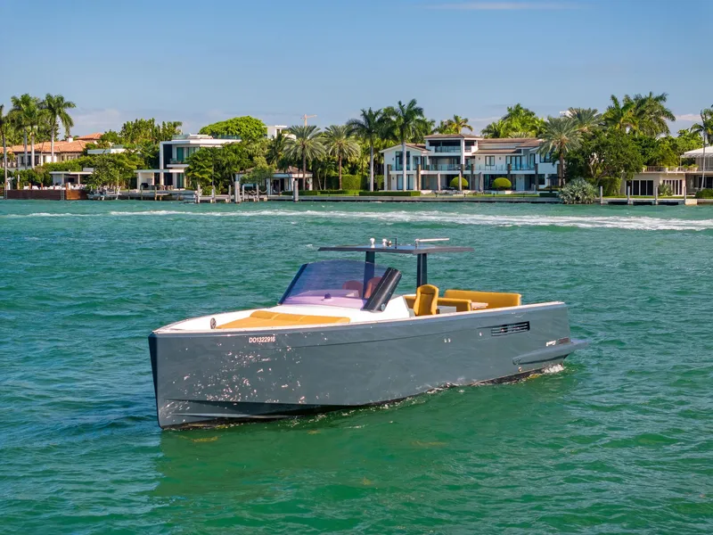 Slide: The Image of Fjord 40 Open 2011 yacht cruising on turquoise waters near luxury waterfront homes. - 7