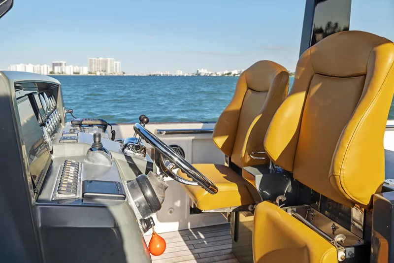 Slide: The Image of Fjord 40 Open 2011 boat interior with tan seats and ocean view. - 9