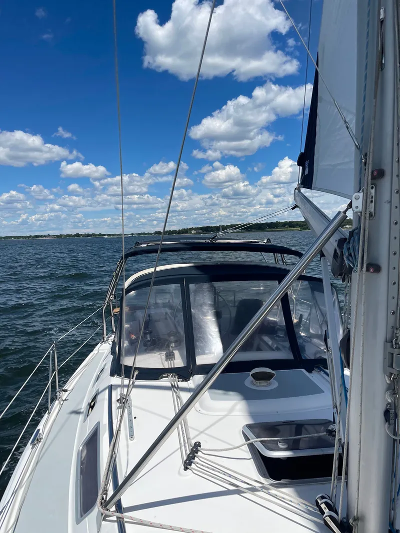 Slide: The Image of Sailboat on the water with clear skies and clouds. - 40