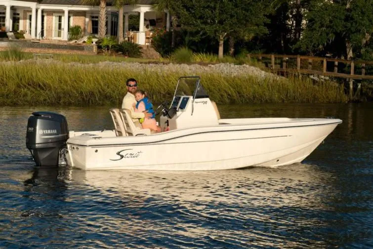 Slide: The Image of Manufacturer Provided Image: 2025 Scout 175 Sportfish boat on calm water near a scenic shoreline. - 12
