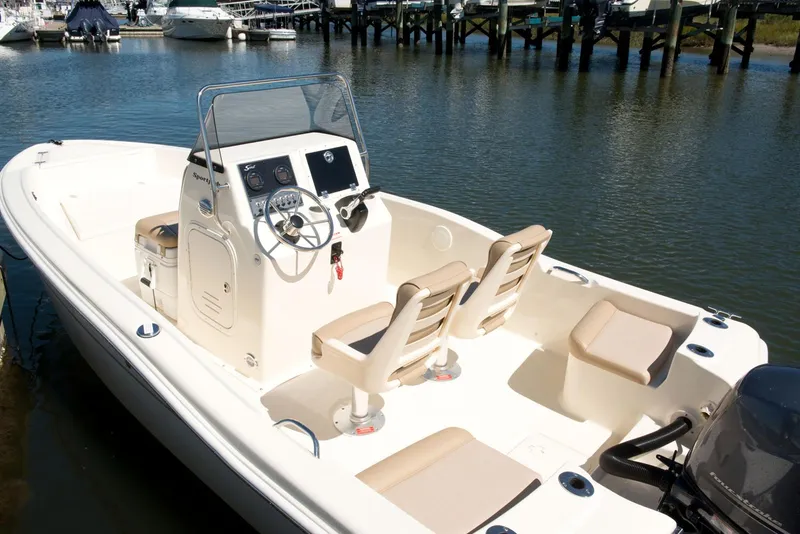 Slide: The Image of Manufacturer Provided Image: 2025 Scout 175 Sportfish boat docked in a marina, featuring a sleek design and modern controls. - 14