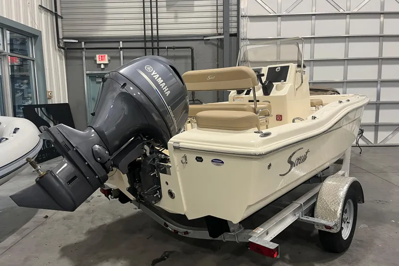 Slide: The Image of 2025 Scout 175 Sportfish boat with Yamaha engine in a garage setting. - 2