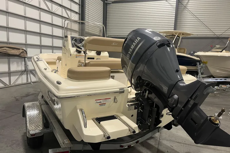 Slide: The Image of 2025 Scout 175 Sportfish boat with Yamaha outboard motor in a garage setting. - 3