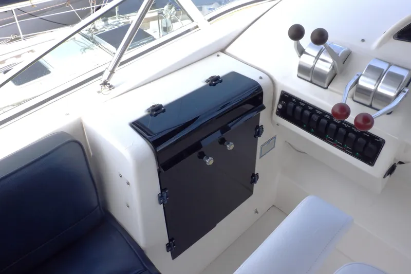 Slide: The Image of 1998 Bayliner 4788 Pilot House Motoryacht helm with controls and seating. - 14