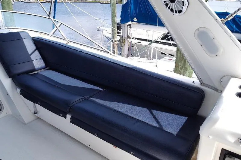 Slide: The Image of 1998 Bayliner 4788 Pilot House Motoryacht with navy seating, docked at marina. - 16