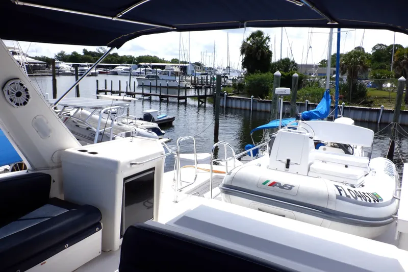 Slide: The Image of 1998 Bayliner 4788 Pilot House Motoryacht docked at marina with inflatable boat. - 22