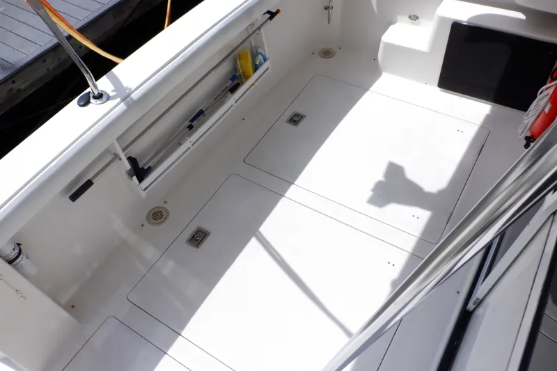 Slide: The Image of 1998 Bayliner 4788 Pilot House Motoryacht deck with storage compartments and safety equipment. - 25