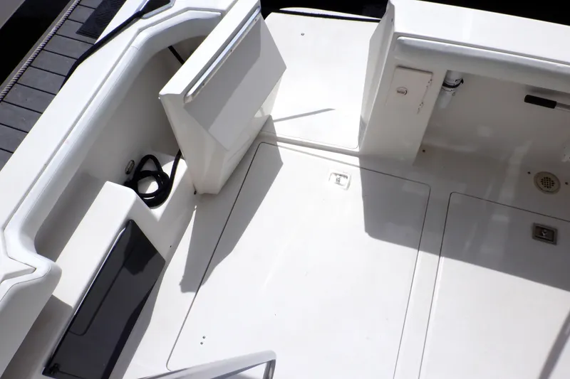 Slide: The Image of 1998 Bayliner 4788 Pilot House Motoryacht deck area with storage compartments and seating. - 26