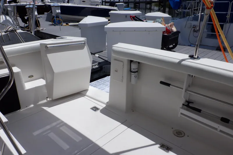 Slide: The Image of 1998 Bayliner 4788 Pilot House Motoryacht deck area with storage compartments and railing. - 28