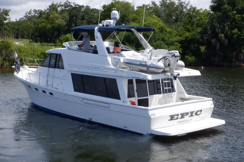 Slide: The Image of 1998 Bayliner 4788 Pilot House Motoryacht cruising on a scenic waterway. - 3