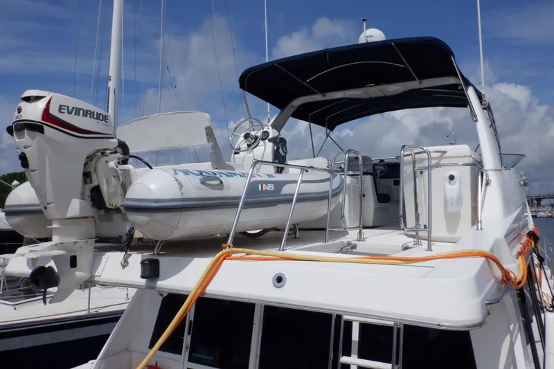 Slide: The Image of 1998 Bayliner 4788 Pilot House Motoryacht with Evinrude motor and inflatable boat on deck. - 31