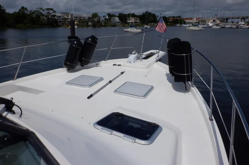 Slide: The Image of 1998 Bayliner 4788 Pilot House Motoryacht deck with hatches and American flag. - 32