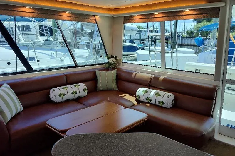 Slide: The Image of Luxurious interior of 1998 Bayliner 4788 Pilot House Motoryacht with leather seating and marina view. - 38