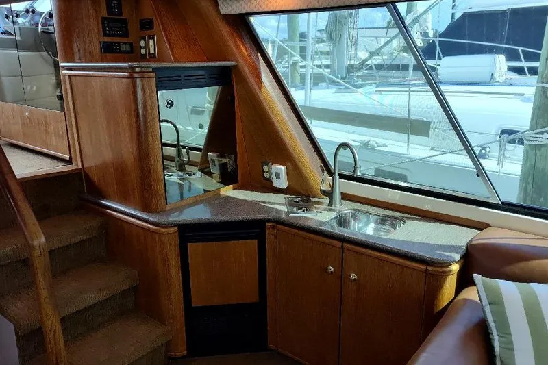 Slide: The Image of Interior of 1998 Bayliner 4788 Pilot House Motoryacht with kitchenette and window view. - 43