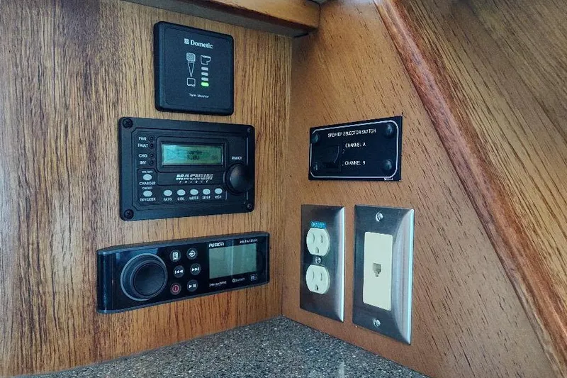 Slide: The Image of 1998 Bayliner 4788 Pilot House Motoryacht control panel with electronic displays and outlets. - 44