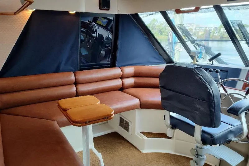 Slide: The Image of Luxurious interior of 1998 Bayliner 4788 Pilot House Motoryacht with leather seating and helm. - 54
