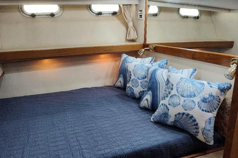 Slide: The Image of Cozy bedroom in 1998 Bayliner 4788 Pilot House Motoryacht with nautical-themed pillows. - 56