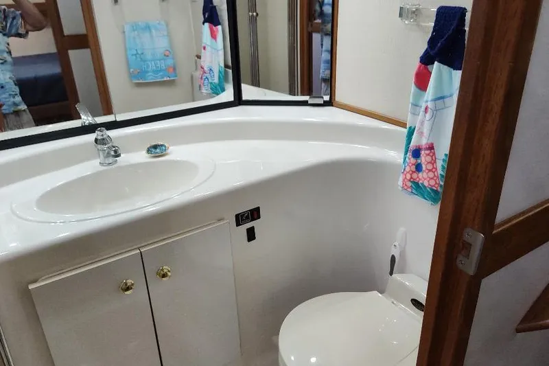 Slide: The Image of Bathroom interior of 1998 Bayliner 4788 Pilot House Motoryacht, featuring sink and toilet. - 59