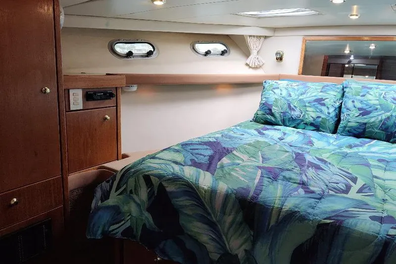 Slide: The Image of Cozy bedroom in 1998 Bayliner 4788 Pilot House Motoryacht with tropical bedding. - 64