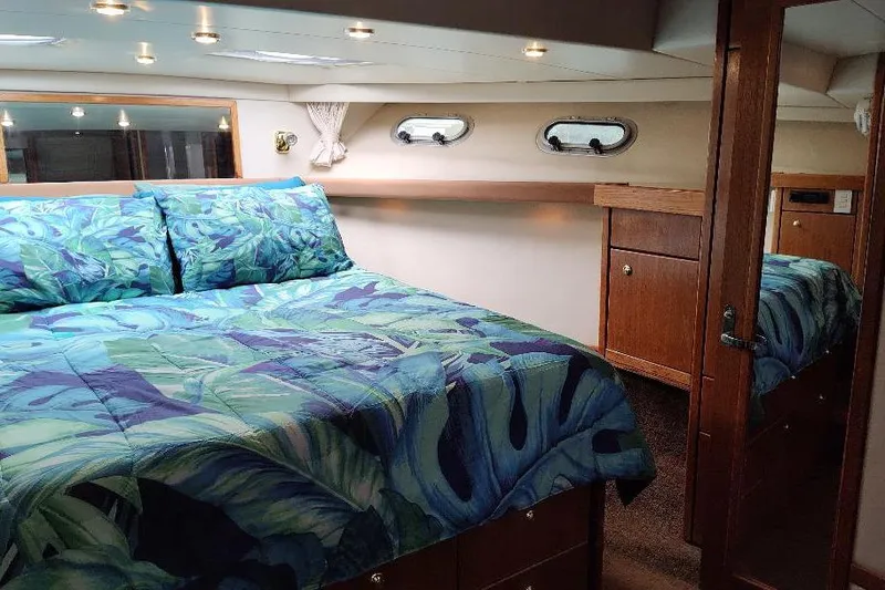 Slide: The Image of Luxurious bedroom interior of 1998 Bayliner 4788 Pilot House Motoryacht with vibrant bedding. - 66