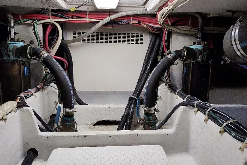 Slide: The Image of Engine room of 1998 Bayliner 4788 Pilot House Motoryacht with visible hoses and wiring. - 75
