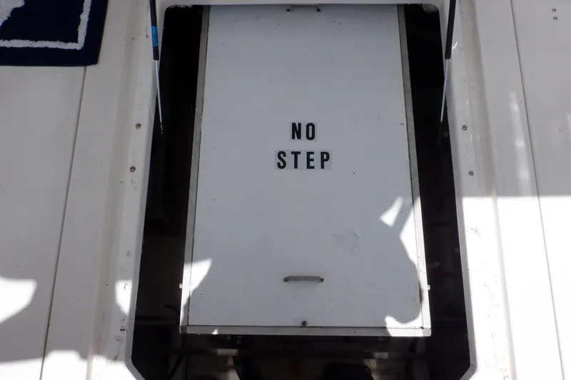 Slide: The Image of Engine hatch with "No Step" sign on 1998 Bayliner 4788 Pilot House Motoryacht. - 76