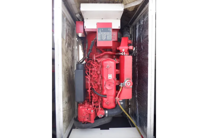 Slide: The Image of Red engine of a 1998 Bayliner 4788 Pilot House Motoryacht in a compartment. - 77