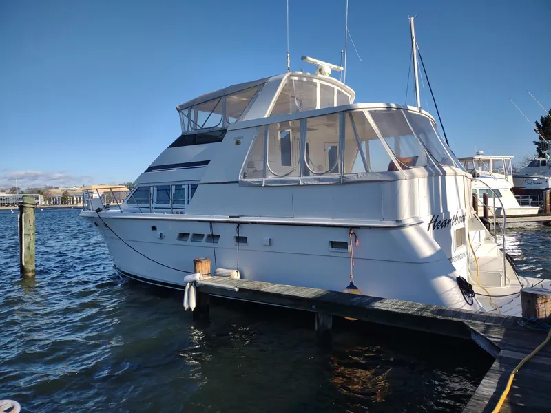 The Image of 1996 Hatteras 50' Sport Deck yacht docked on a sunny day. - 0