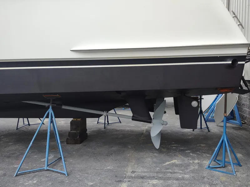 Slide: The Image of 1996 Hatteras 50' Sport Deck yacht on stands, showing propeller and hull details. - 10