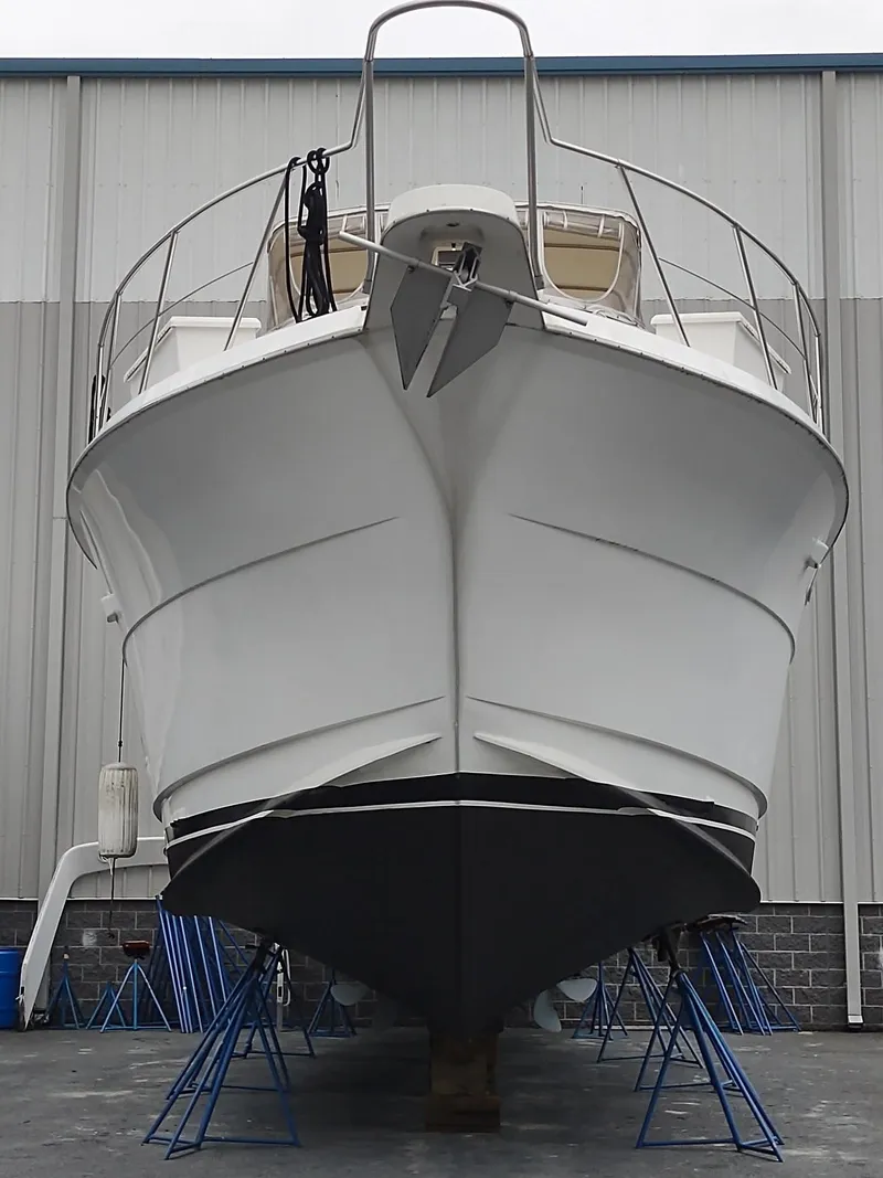 Slide: The Image of 1996 Hatteras 50' Sport Deck yacht on stands in a boatyard. - 11
