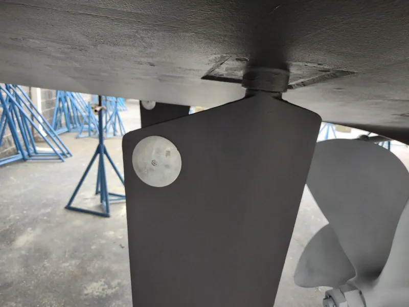 Slide: The Image of 1996 Hatteras 50' Sport Deck boat underside with propeller and rudder detail. - 16