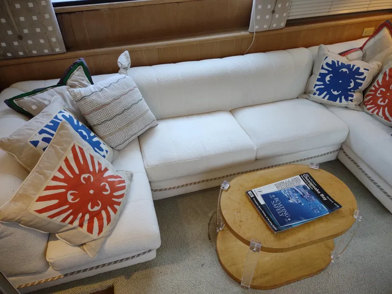 Slide: The Image of Luxurious 1996 Hatteras 50' Sport Deck interior with white sofa and colorful cushions. - 18