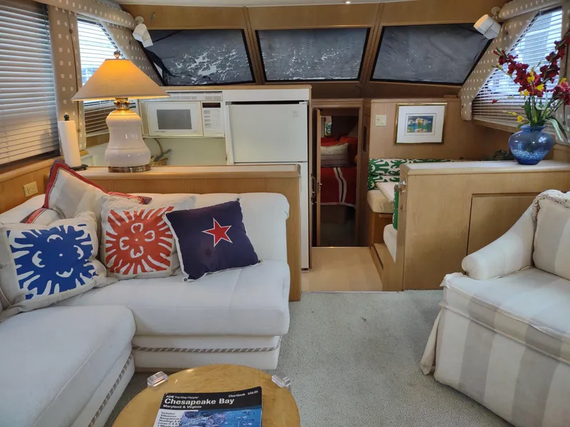 Slide: The Image of Interior of 1996 Hatteras 50' Sport Deck yacht with cozy seating and nautical decor. - 23
