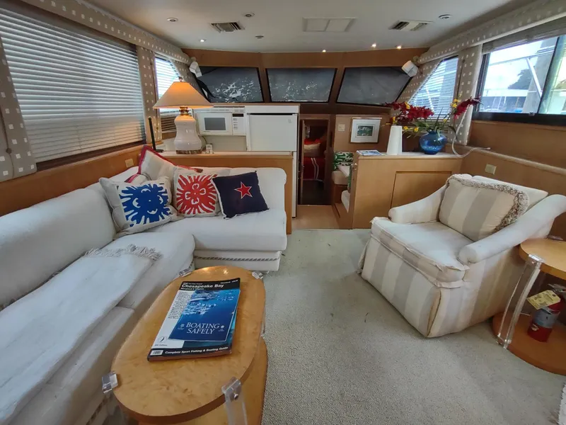 Slide: The Image of Interior of 1996 Hatteras 50' Sport Deck yacht with cozy seating and nautical decor. - 24