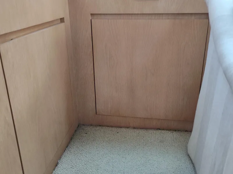 Slide: The Image of Interior of 1996 Hatteras 50' Sport Deck with wood paneling and carpeted floor. - 27