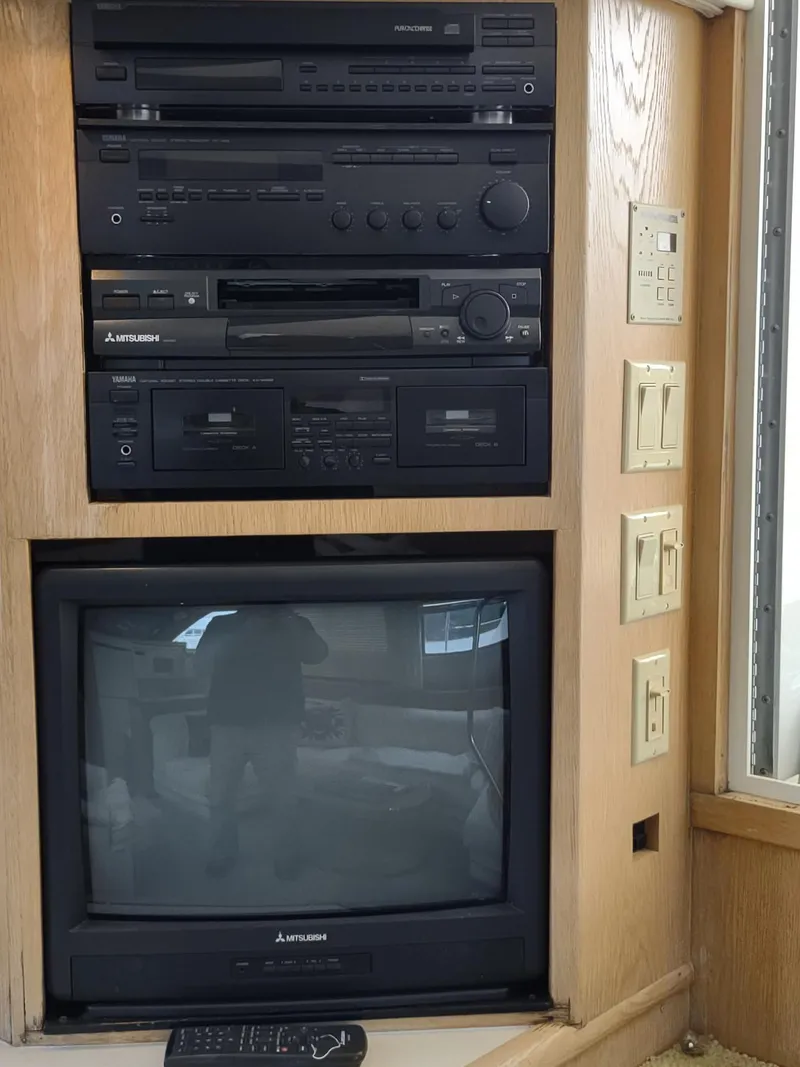 Slide: The Image of Entertainment system with vintage electronics and TV on a 1996 Hatteras 50' Sport Deck yacht. - 34
