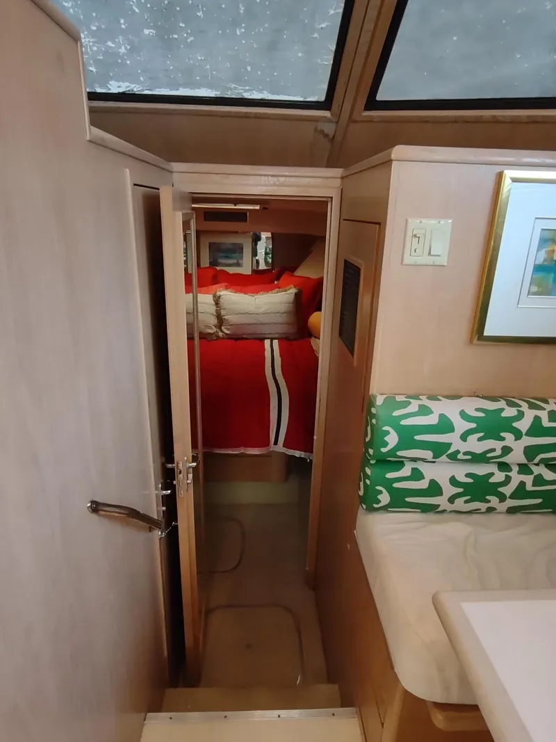 Slide: The Image of Interior of 1996 Hatteras 50' Sport Deck with cozy bedroom and vibrant decor. - 47