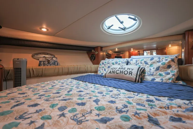 Slide: The Image of Luxurious 2004 Meridian 411 Sedan bedroom with nautical-themed bedding and decorative pillow. - 18