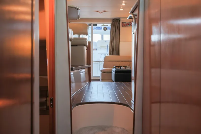 Slide: The Image of Interior view of 2004 Meridian 411 Sedan yacht with luxurious seating and wooden flooring. - 20