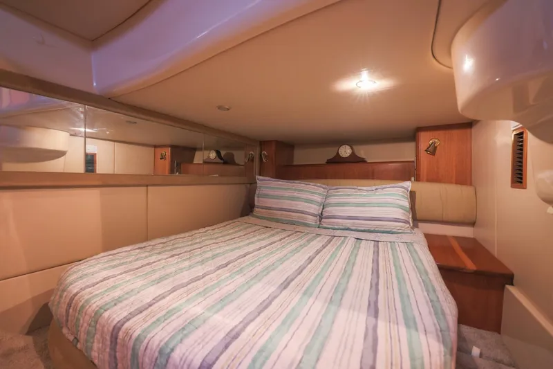 Slide: The Image of Luxurious bedroom interior of 2004 Meridian 411 Sedan yacht with striped bedding. - 21