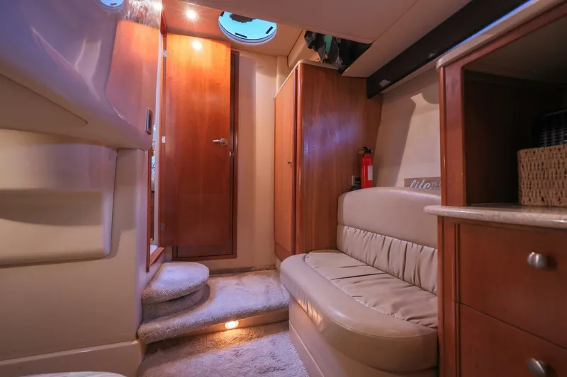 Slide: The Image of Interior of 2004 Meridian 411 Sedan yacht, featuring cozy seating and wooden cabinetry. - 22