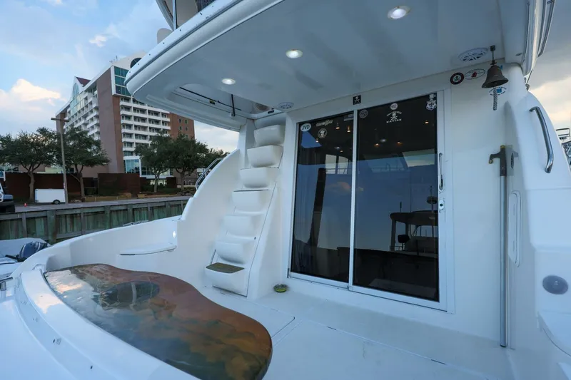 Slide: The Image of 2004 Meridian 411 Sedan yacht with sleek design, docked near modern building. - 24