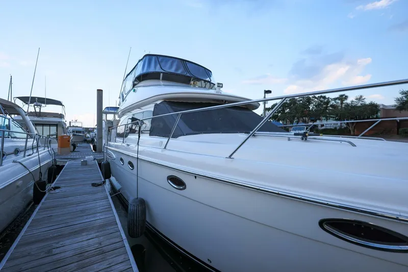 Slide: The Image of 2004 Meridian 411 Sedan yacht docked at marina under blue sky. - 28