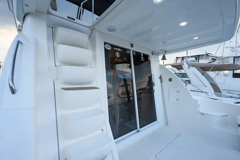 Slide: The Image of 2004 Meridian 411 Sedan yacht with sleek white exterior and modern design features. - 29