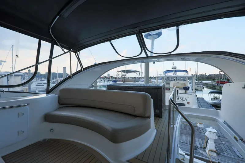 Slide: The Image of 2004 Meridian 411 Sedan yacht interior with seating, docked at marina. - 33