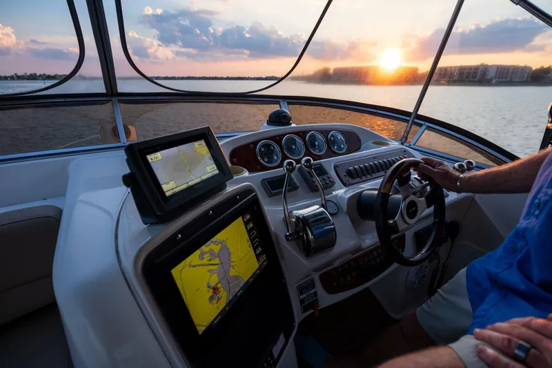 Slide: The Image of Cockpit of 2004 Meridian 411 Sedan yacht at sunset, featuring navigation equipment. - 37