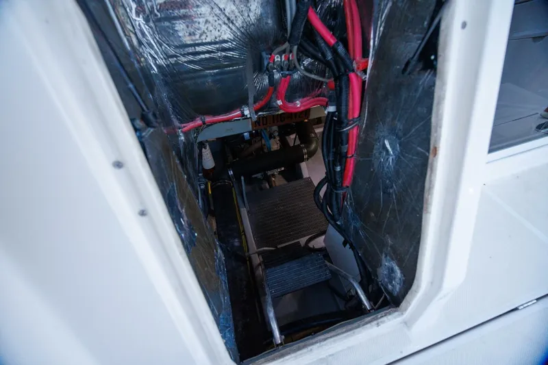 Slide: The Image of Engine room of a 2004 Meridian 411 Sedan with visible wiring and components. - 39