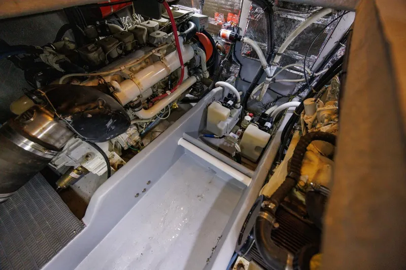 Slide: The Image of Engine room of a 2004 Meridian 411 Sedan boat, showcasing mechanical components. - 44