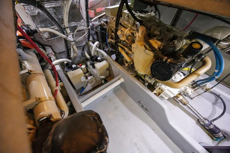 Slide: The Image of Engine room of a 2004 Meridian 411 Sedan yacht, showcasing mechanical components and wiring. - 45
